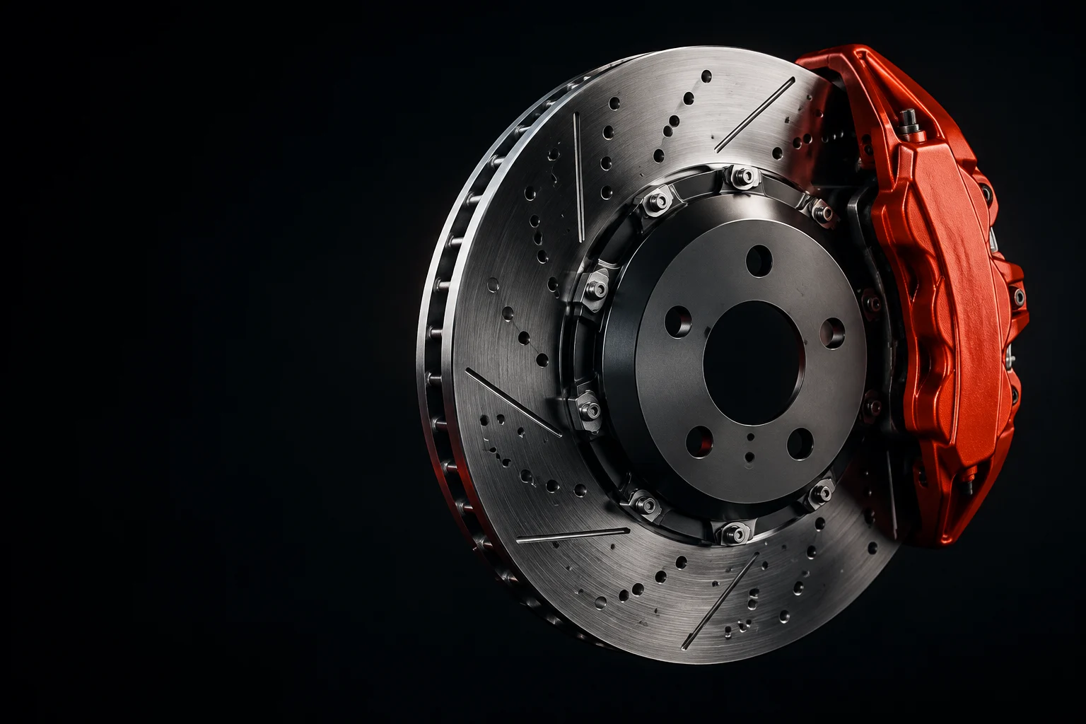 Illustrative studio close-up of a brake disc and red caliper.